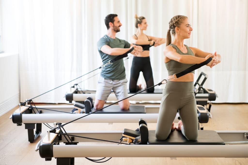 pilates students on reformers